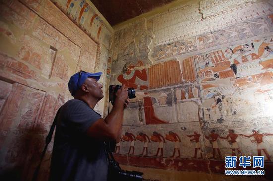 9月8日，在埃及吉萨省塞加拉地区，一名男子在古墓内拍摄。