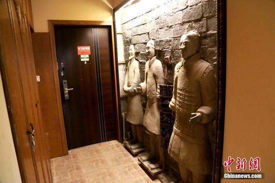 11月27日，民宿进门处的三尊“兵马俑”装饰如同门神。 中新社记者 张远 摄